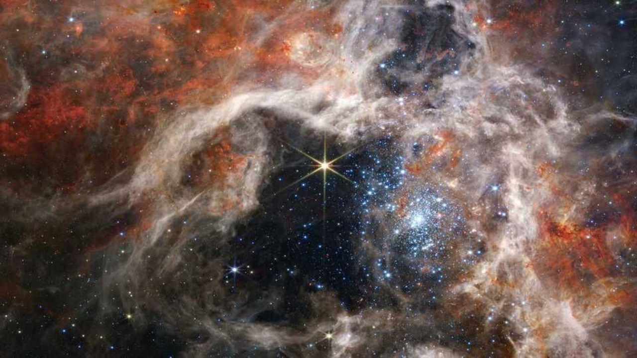 Colorful nebula with bright stars and swirling gas clouds in space.