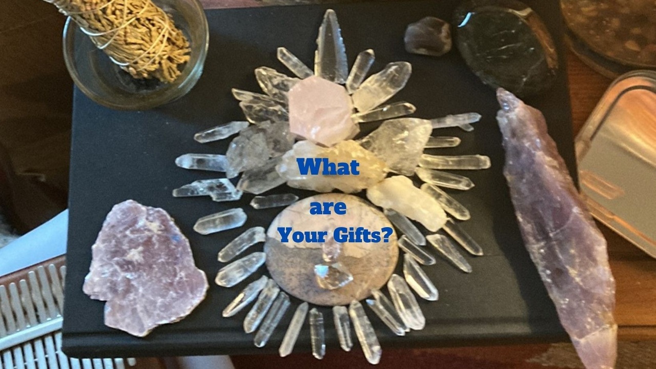 Crystals arranged with quartz points radiating from a central cluster, including rose quartz and amethyst. The text "What are Your Gifts?" is overlaid on the image.